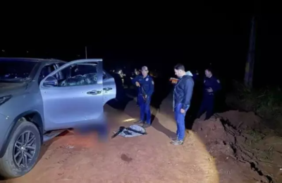 Policiais ao lado da SUV da Toyota ocupada por homens mortos ontem à noite.