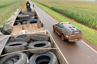 Policial sobre a carreta lotada de pneus contrabandeados, apreendida na MS-386.