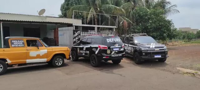 Equipes da Defurv em frente da oficina onde placas eram fabricadas. (Foto: Divulgação/PCMS)