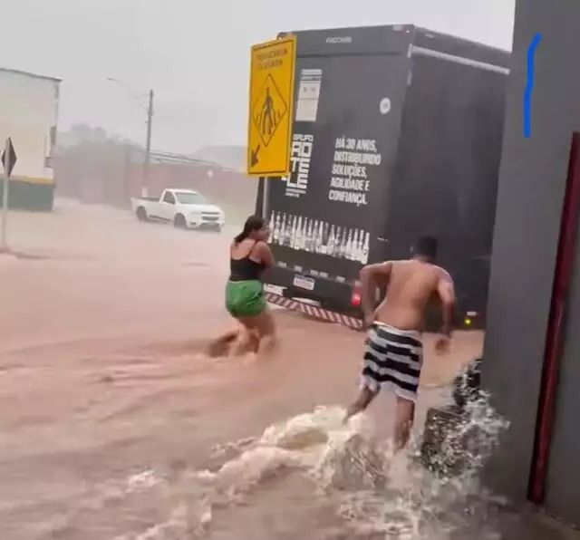 Mulher precisou se agarrar em placa de sinalização para evitar ser arrastada. Foto: Reprodução/Rede Social